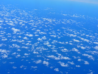 Aerial view of scattered white clouds in a deep blue sky