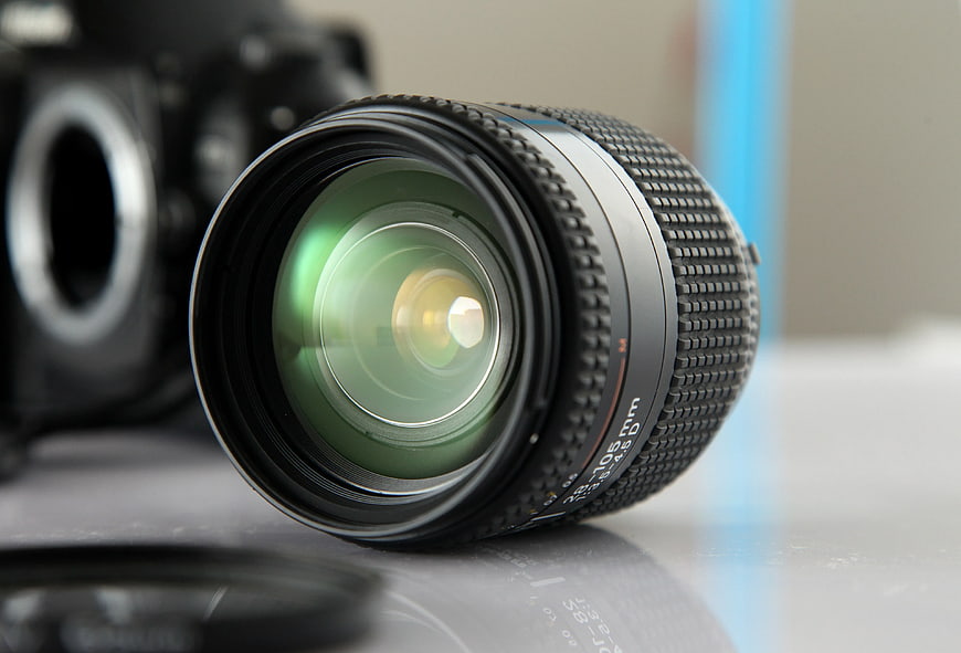 Close-up of Black Camera Lens on White Surface