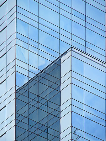 Modern Glass Skyscraper Facade with Blue Sky Reflection