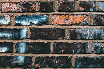 Textured Old Brick Wall with Blue and Orange Paint