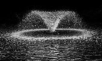 Dramatic black and white water splash against dark background