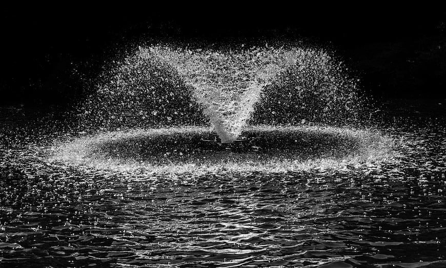 Dramatic black and white water splash against dark background