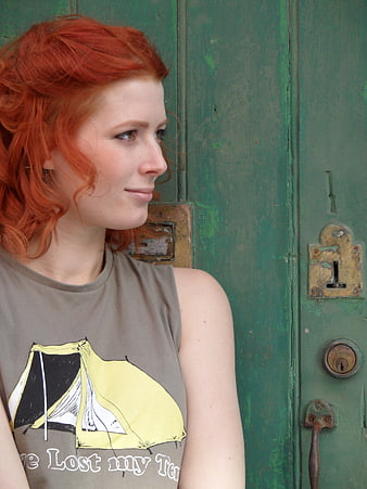 Redhead woman in profile against vintage green door