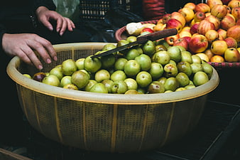 Fresh Green Apples in Woven Basket at Market