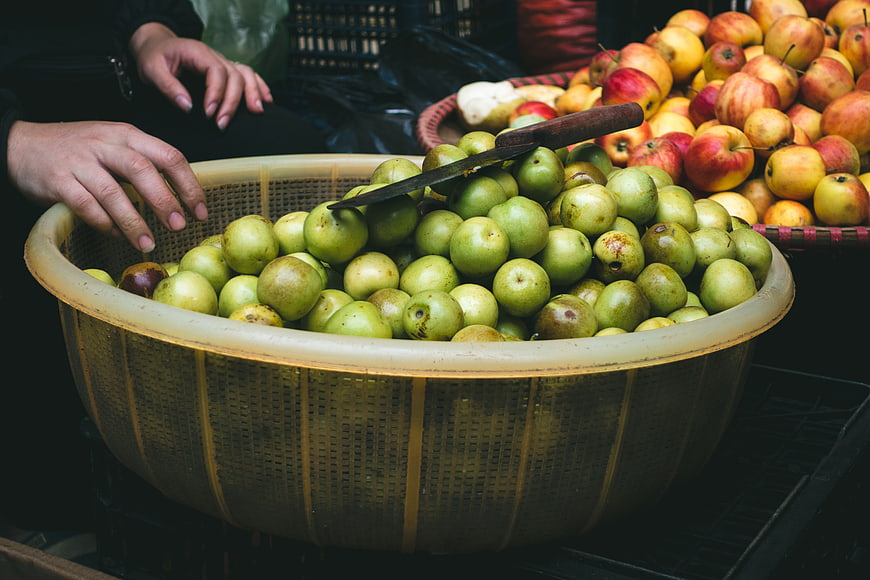 Fresh Green Apples in Woven Basket at Market