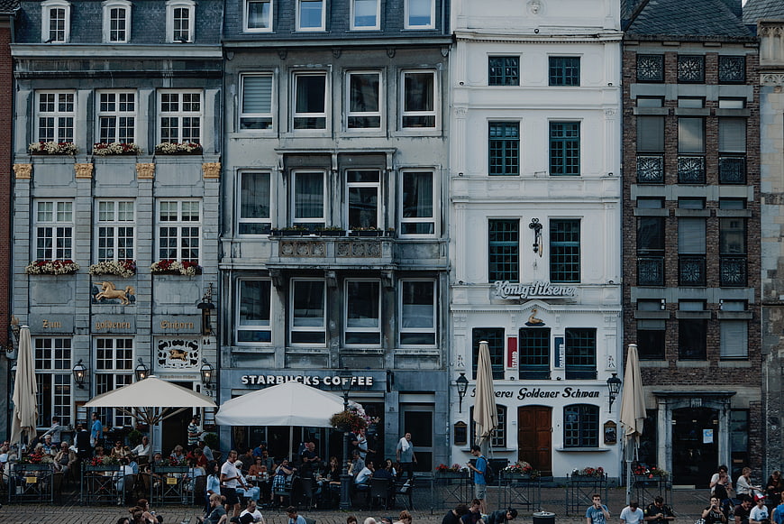European city square with historic buildings and outdoor cafes