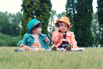 Two Toddlers Playing with Vintage Radio in Park