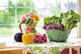 Fresh Vegetables and Flowers on Kitchen Table by Window