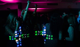 Silhouettes of People Dancing in a Dark Club with Disco Lights