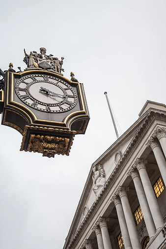 Ornate Black and Gold Clock on Classical Building