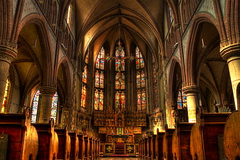 Gothic Church Interior with Stained Glass Windows and Brick Arches