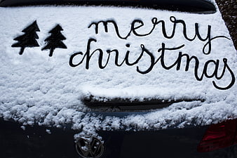 Merry Christmas Handwritten in Snow on Car Trunk