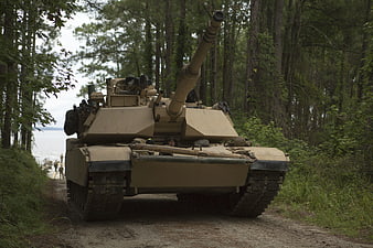 M1A1 Abrams Tank Moving On Forest Trail Near Water