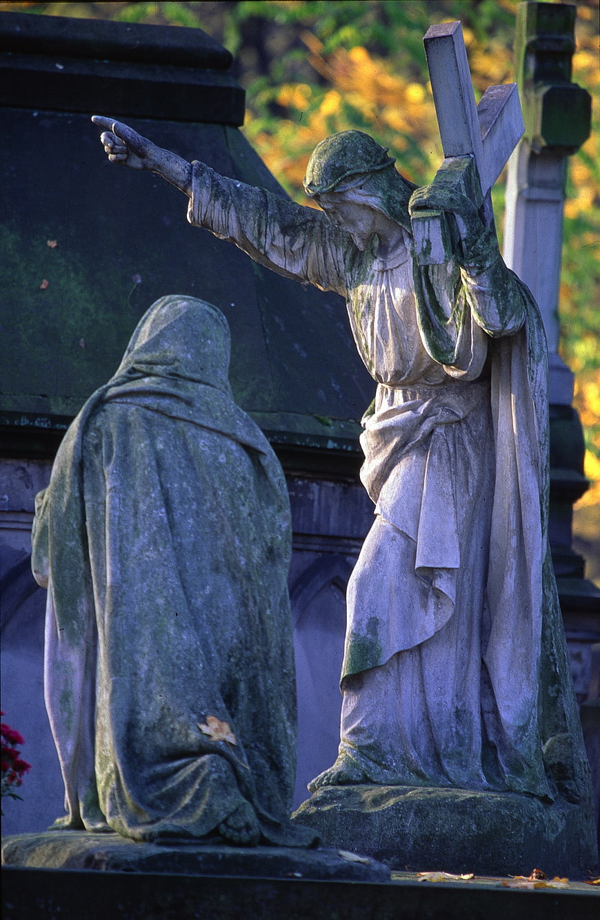 Weathered Stone Cemetery Statues Depicting Religious Scene