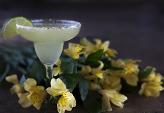 Yellow Margarita Cocktail with Lime Garnish and Flowers