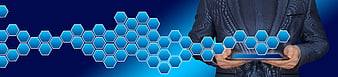 Businessman Holding Tablet With Blue Hexagonal Blockchain Network Graphic
