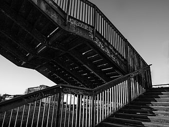 Black and white urban metal staircase with graffiti