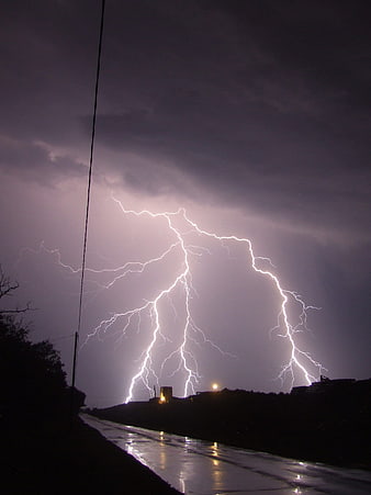 Dramatic Night Lightning Strike Over Wet Road