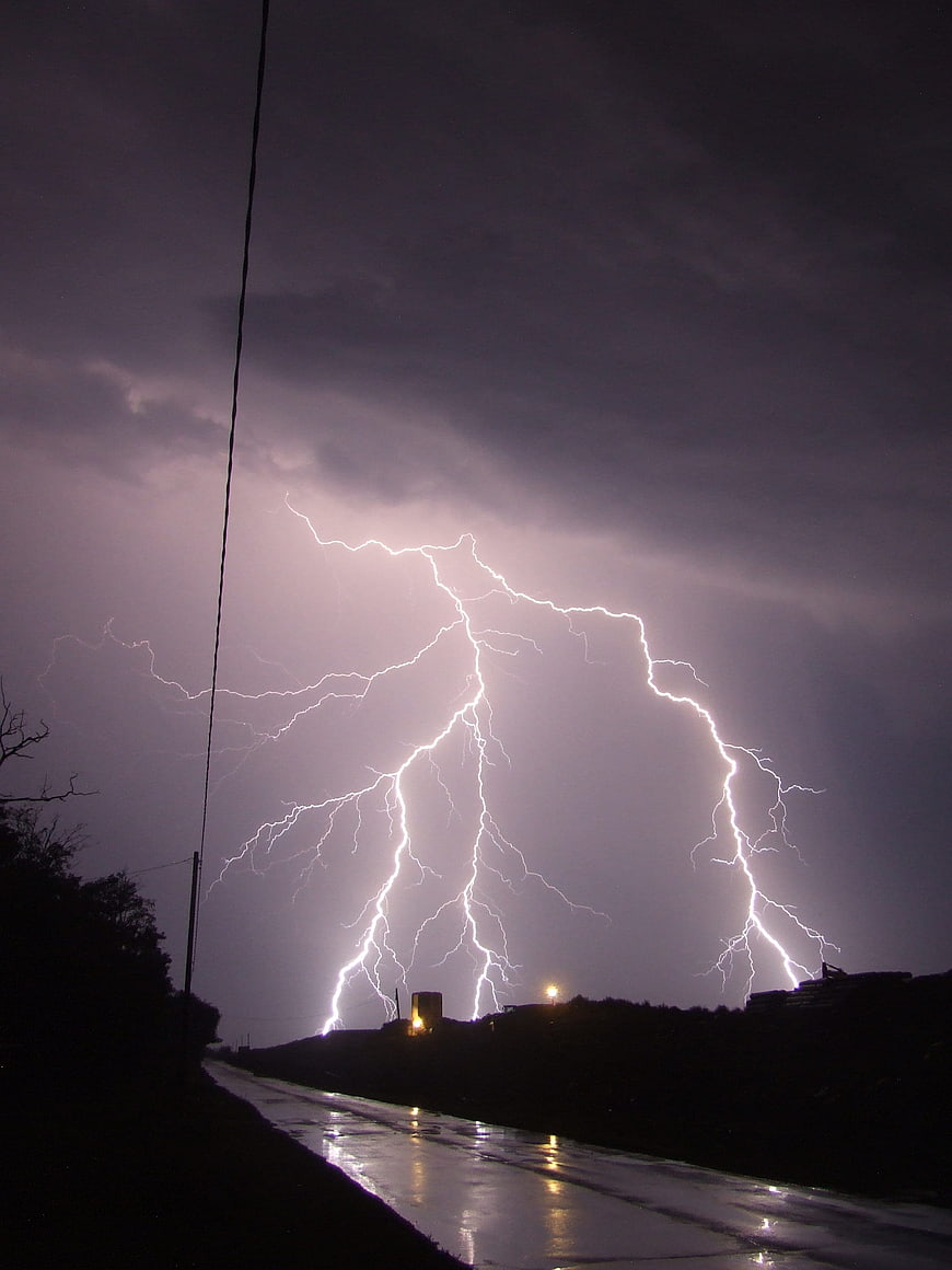 Dramatic Night Lightning Strike Over Wet Road
