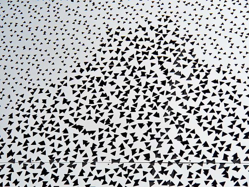 Black Triangle Confetti Scattered on White Background