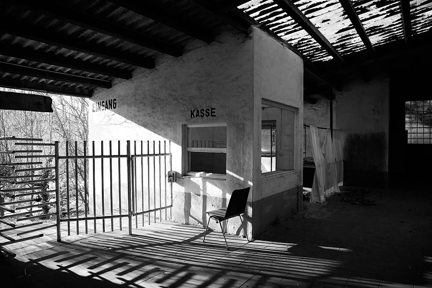Abandoned Building Interior with German Text and Shadows