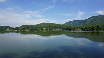 Serene lake with mountain reflections and wooden pier