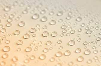Macro Water Droplets on Warm Beige Surface