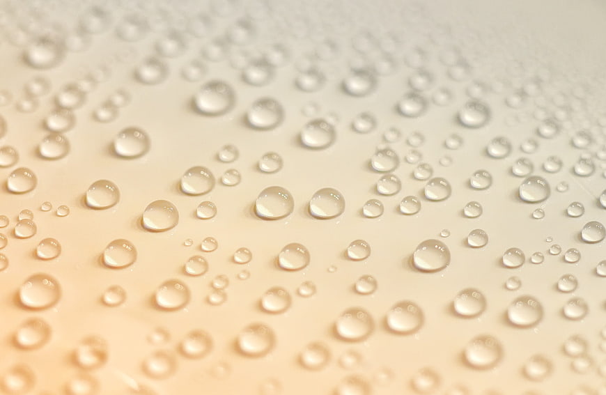 Macro Water Droplets on Warm Beige Surface