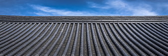 Traditional Korean Hanok Roof Tiles Against Blue Sky