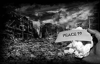 Hand holding peace note in war-torn ruins