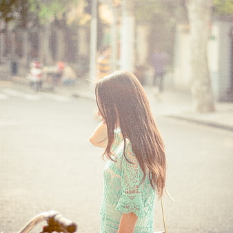 Woman in Mint Lace Dress Walking on Sunny Street