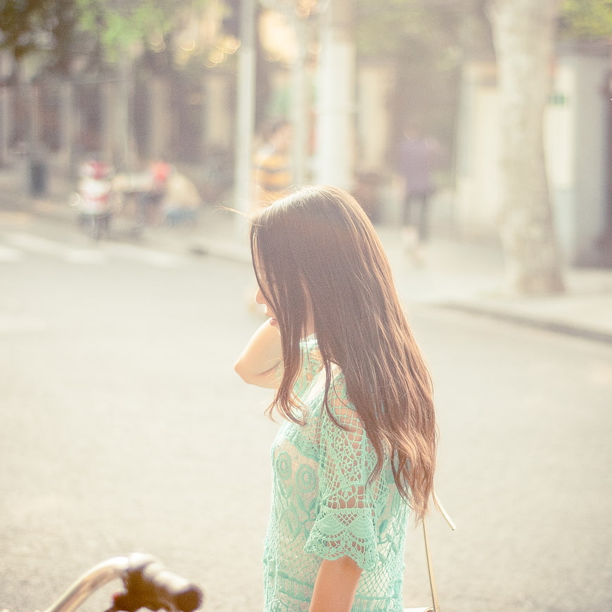 Woman in Mint Lace Dress Walking on Sunny Street