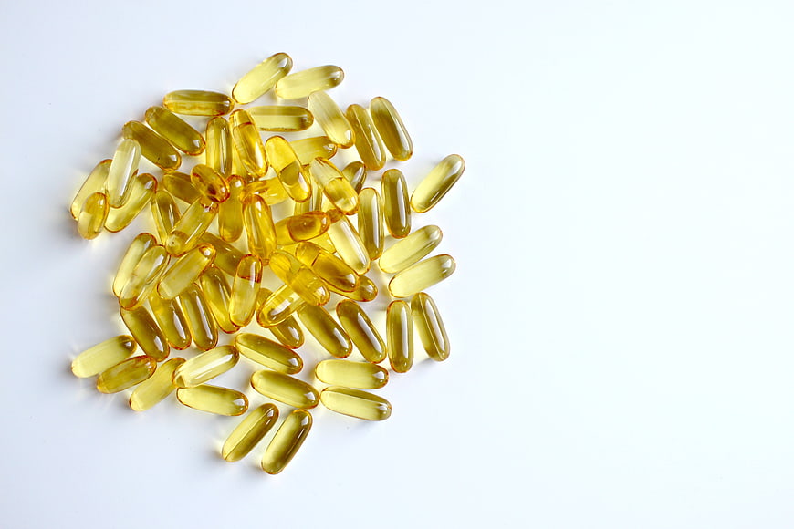 Yellow Fish Oil Softgel Capsules on White Background
