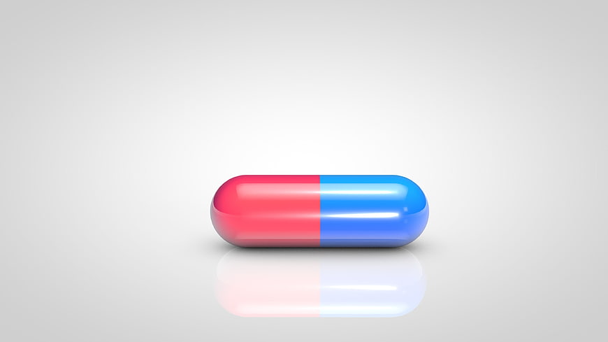 Red and Blue Medicine Capsule on White Background