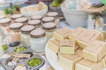 Handmade artisan soap bars and candles on display table