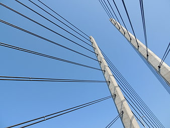 Low Angle View of Cable-Stayed Bridge Towers Against Blue Sky