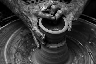 Close-up of hands shaping clay on a pottery wheel