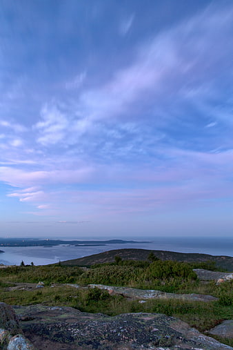 Scenic Coastal Landscape with Rocky Foreground and Blue Sky