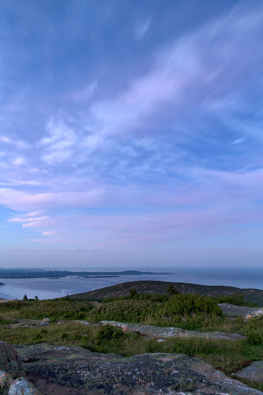 Scenic Coastal Landscape with Rocky Foreground and Blue Sky