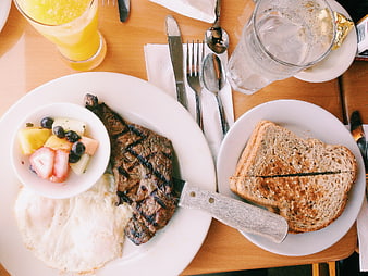 Overhead view of grilled steak breakfast with eggs and toast
