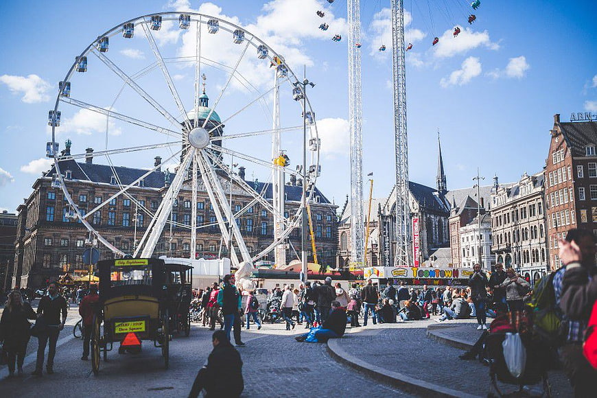 Ferris Wheel and Amusement Park in European City Square