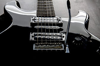 Close-up of Black Electric Guitar Body and Pickups