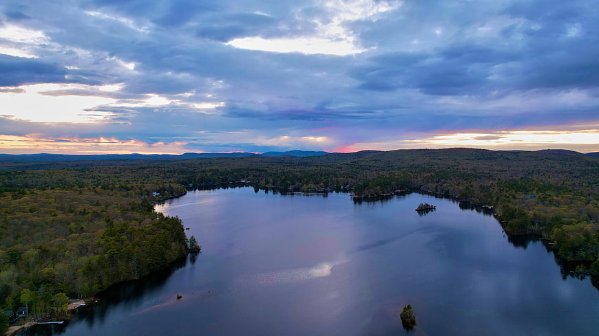 Aerial View of Serene Lake at Dusk with Colorful Clouds