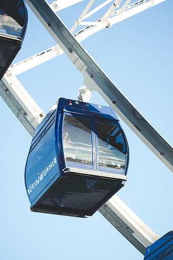 Blue Ferris Wheel Cabin Against Clear Blue Sky
