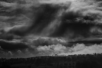 Dramatic Black and White Storm Clouds Over Rolling Hills