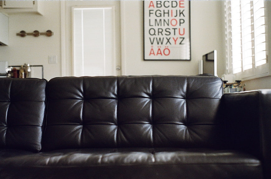 Black Leather Sofa in Modern Living Room with Alphabet Art