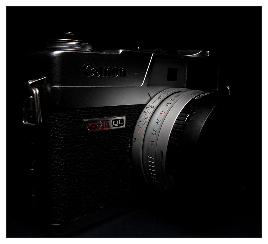 Vintage Canon G-III QL Film Camera on Black Background