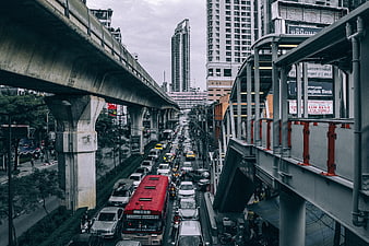 Heavy Traffic on Bangkok Street Under Elevated Skytrain Tracks