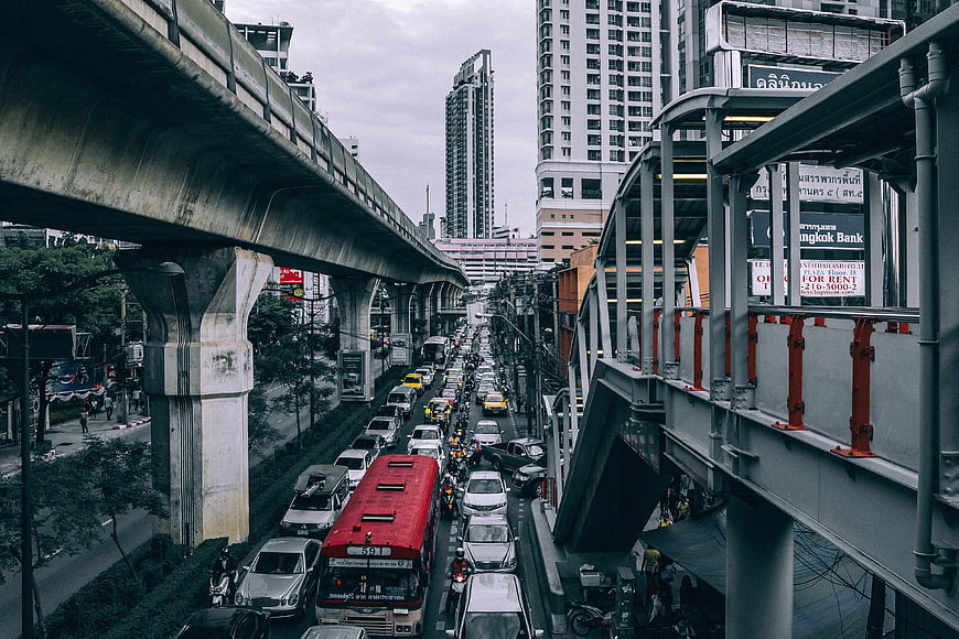 Heavy Traffic on Bangkok Street Under Elevated Skytrain Tracks
