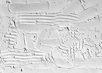 White textured plaster wall surface with abstract paint strokes